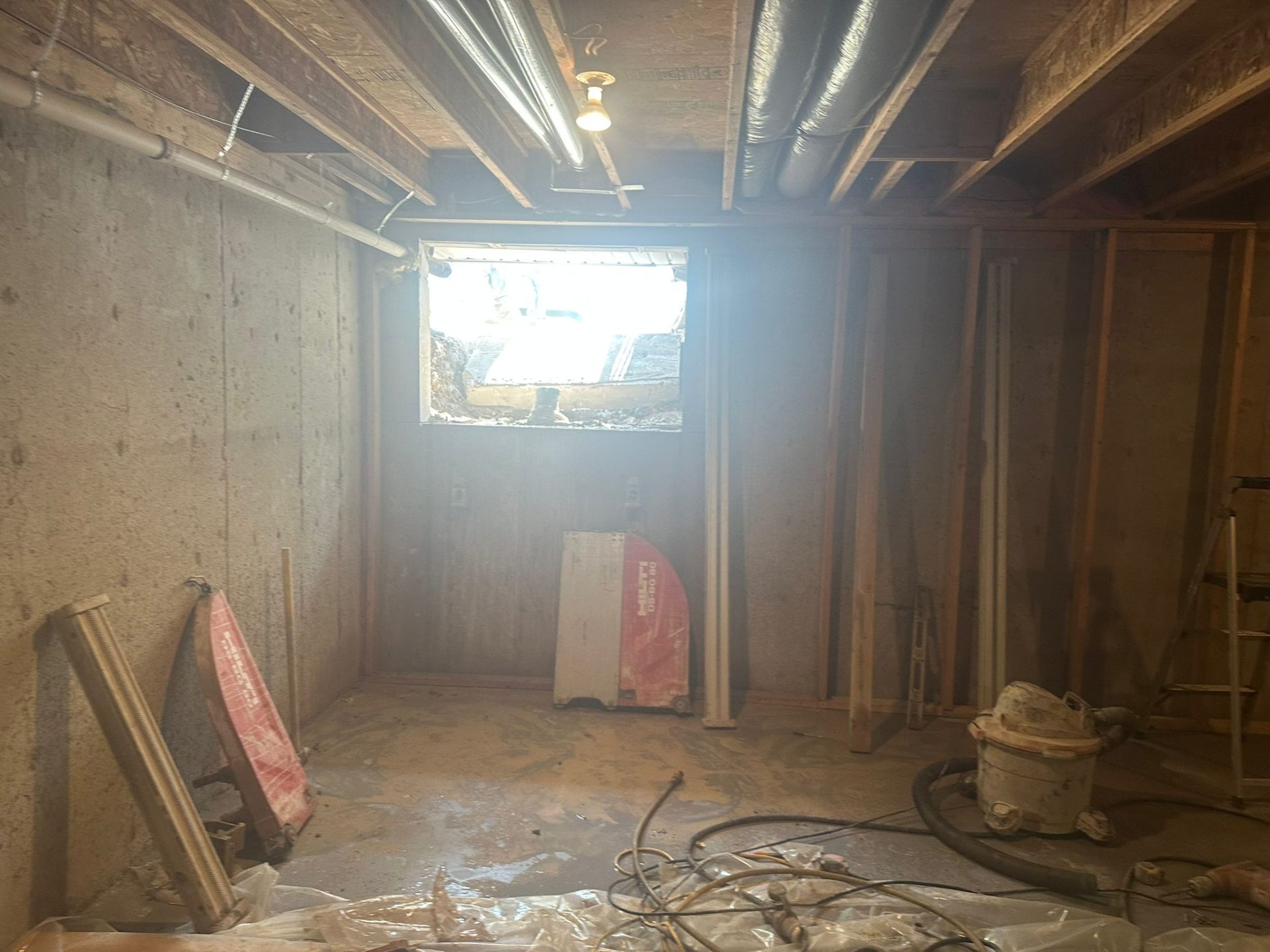 Concrete foundation wall cut open for a new egress window during basement renovation