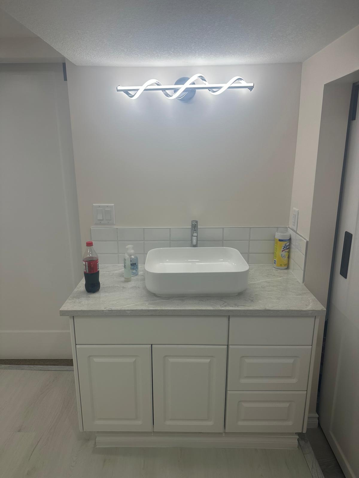LED wave vanity light bar mounted above the bathroom mirror, casting bright even light