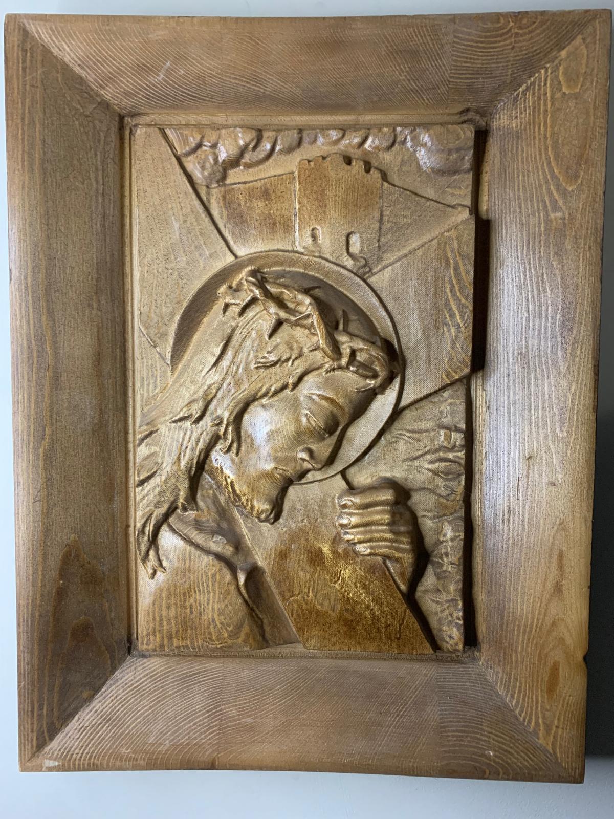 Hand-carved relief of Christ bearing the cross, framed in solid wood