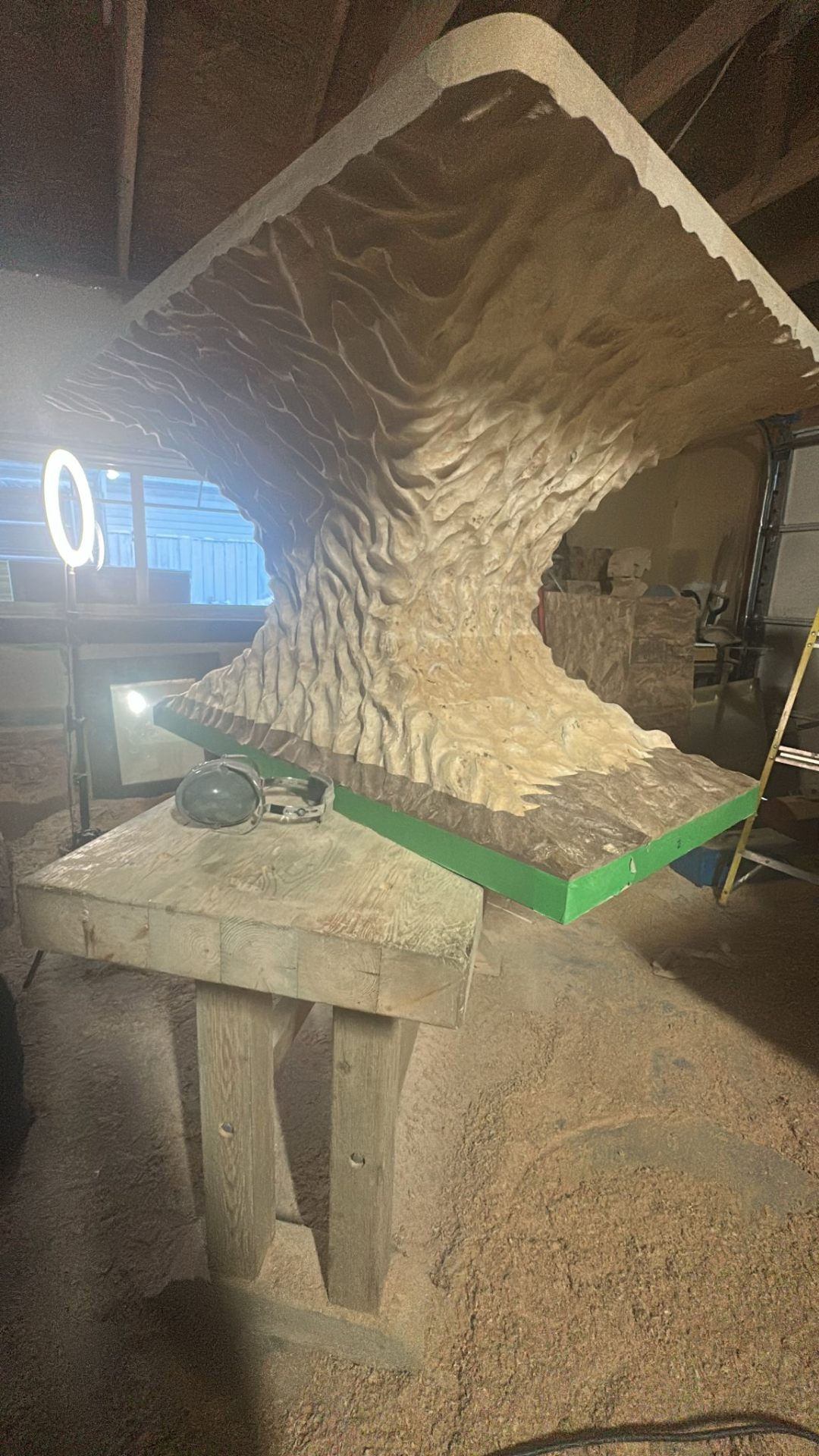 Monumental hand-carved wave sculpture in the workshop