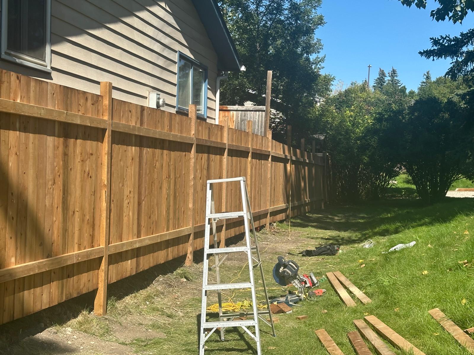 Completed cedar fence with horizontal rails and vertical pickets along a Calgary residential property